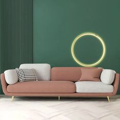 a living room with green walls and a pink couch in front of a circular light