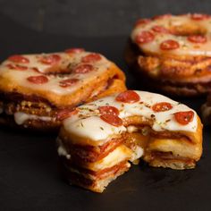 three pieces of pizza sitting on top of a black surface