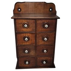 an old wooden dresser with six drawers and knobs on the bottom drawer, isolated against a white background