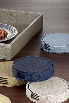 four plates with donuts on them sitting in front of a box