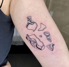 a woman with a tattoo on her arm that has different shapes and sizes of shoes