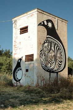 an old building with a bird painted on it