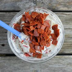 a glass bowl filled with food on top of a wooden table