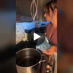 a woman is cooking in the kitchen with pots and pans on the stove top