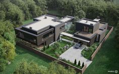 an aerial view of a modern house in the middle of trees and grass, with two cars parked on the driveway