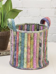 a basket that is sitting on top of a table next to a potted plant