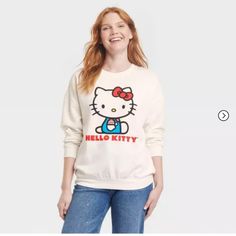 Snuggle Up In Style With Our Women's Hello Kitty Cozy Graphic Sweatshirt - White. Designed For Both Comfort And Fashion, It Has Ribbed Cuffs And A Round Neck. The Delightful Hello Kitty Print Adds A Dash Of Graphic Fun. Celebrate Your Love For Hello Kitty With The Soft, Women's Graphic Sweatshirt In White. Casual Cotton Sweatshirt With Hello Kitty Print, Hello Kitty Cotton Sweatshirt In Kawaii Style, Hello Kitty Print Crew Neck Cotton Sweatshirt, Trendy Hello Kitty Print Crew Neck Sweatshirt, Cotton Crew Neck Sweatshirt With Hello Kitty Print, Cute Cartoon Print Tops For Loungewear, Cute Tops With Cartoon Print For Loungewear, Cute Cozy Fit Long Sleeve Tops, Cute Hello Kitty Print Crew Neck Sweatshirt