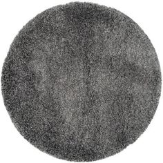 a round gray rug is shown on a white background with no one in the photo