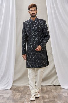 Black sherwani with floral embroidery and mandarin collar. Paired with cream churidar.
Component: 2
Pattern: Embroidered
Type Of Work: Floral
Neckline: Mandarin
Sleeve Type: Full Sleeves
Fabric: Art Banarasi Silk, Dupion Art Silk
Color: Black
Other Details: 
Floral embroidery
Front buttons
Note: Pocket square worn by the model is not for sale
Occasion: Wedding - Aza Fashions Black Sherwani, Embroidered Sherwani, Churidar, Full Sleeves, Embroidered Silk, Fabric Art, Mandarin Collar, Double Breasted Suit Jacket, Black Art