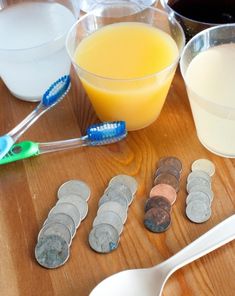 the table is full of toothbrushes, spoons, and other dental care items