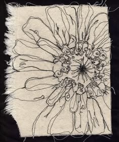 a black and white drawing of a flower on a piece of cloth with fringes