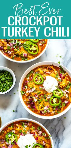 the best ever crockpot turkey chili recipe in two bowls with sour cream on top