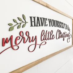 a sign that says have yourself merry little christmas on the side of a white wall