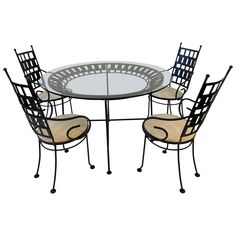 a glass table and four chairs with metal frame around the top, set against a white background