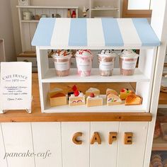 an ice cream stand with various desserts on it