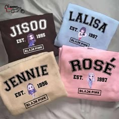 three t - shirts with the names of four different women on them, one in pink, one in blue and one in black