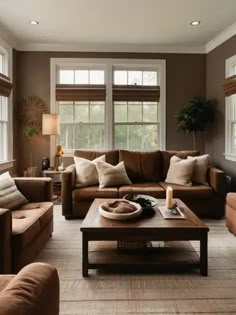 a living room filled with lots of brown furniture