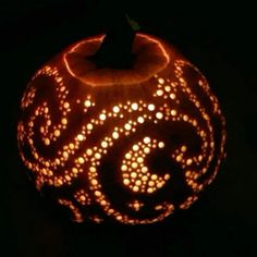 a carved pumpkin with an intricate design on it