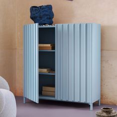 a blue cabinet sitting in the corner of a room