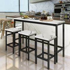 three stools sit at the center of a kitchen island