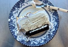 a piece of cake sitting on top of a blue and white plate next to a fork