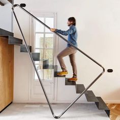 a man walking up the stairs in his home