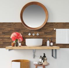 a bathroom with a round mirror above the sink