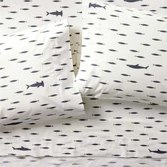 two pillow cases with black and white fish on them