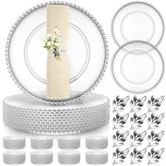 a table setting with plates, napkins and flowers on the plate stand next to each other