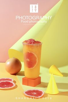 an orange and grapefruit drink sitting on top of a yellow table