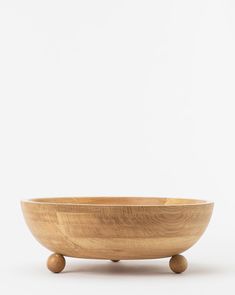 a wooden bowl sitting on top of a table