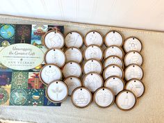 twelve ceramic ornaments are on display in front of a children's book and an ornament