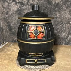 an old fashioned stove sitting on top of a wooden table