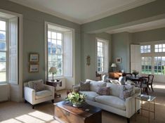 a living room filled with furniture and windows