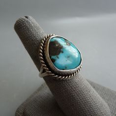 Arizona Turquoise Ring, Navajo Turquoise Ring, Native American Turquoise Ring, Southwest Turquoise Jewelry, December Birthstone Gift For Her This listing is for a beautiful vintage Native American sterling silver ring with a large turquoise gemstone cabochon, size 6-3/4.  This ring is probably a Navajo design and it has a large bezel set sky blue turquoise gemstone which I believe is from Arizona.  The band is a split style.  The triangular shaped bezel set setting has a rope design and measures Vintage Sterling Silver Turquoise Ring With Large Stone, Antique Turquoise Sterling Silver Ring, Native American Turquoise Ring, Native American Turquoise, Arizona Turquoise, American Turquoise, Navajo Turquoise, Birthstone Gifts, Rope Design