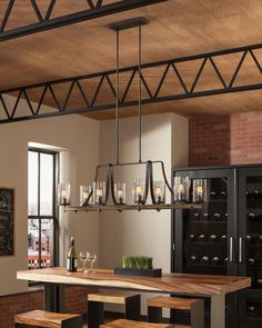 a dining room table with wine glasses and bottles on the top shelf in front of it