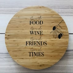 a cutting board with the words good food, wine and friends good times on it