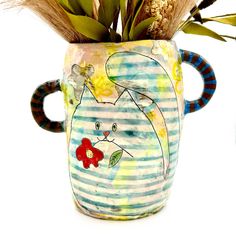 a ceramic vase with an animal painted on it