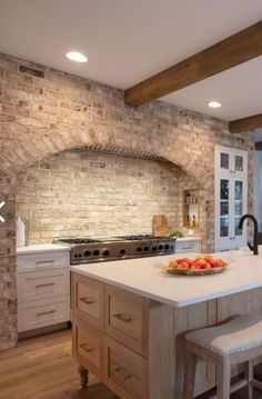 a kitchen with an island, stove and sink