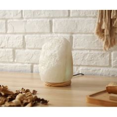 a small white object sitting on top of a wooden table next to some wood shavings