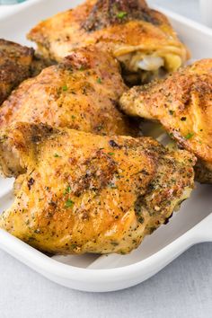 a white plate topped with chicken wings covered in seasoning