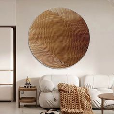 a living room filled with white furniture and a large circular wall art piece on the wall