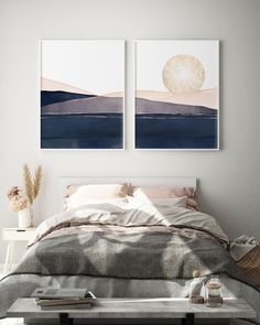 two paintings on the wall above a bed