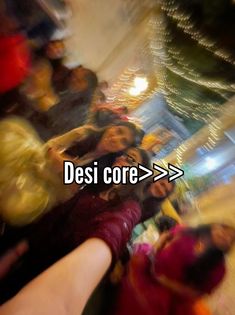 blurry photograph of people standing in front of a store with the words desi core on it