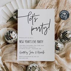 a new year's eve party with disco balls and a card that says lets party