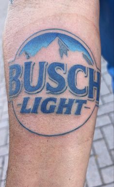 a close up of a person with a tattoo on his leg that says busch light