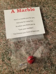 a card that has been placed on top of a marble counter with a red heart in it