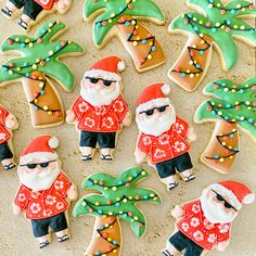 decorated christmas cookies with santa clause and palm trees on sand area next to beach scene