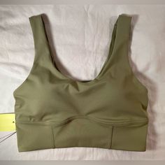 This Is A Light Support Sports Bra Made With Smooth Fabric To Help You Feel Supported. It’s Moisture Wicking And A Longline Length. Has Removable Pad, Comfort Straps, And Flat Seams For Comfort. Size Small Will Fit: 32c, 34a, 34b, 36a Body: 75% Recycled Polyester And 25% Spandex. Lining: 86% Recycled Polyester, 8% Spandex, And 6% Polyester. Machine Wash Cold Gentle Cycle, Tumble Dry Low. Casual Nylon Sports Bra With Built-in Padding, Khaki Athleisure Activewear For Sports, Casual Solid Color Nylon Sports Bra, Khaki Athleisure Activewear, Fitted Khaki Sporty Activewear, Sporty Fitted Khaki Activewear, Khaki Athleisure Activewear For Workout, Fitted Khaki Athleisure Activewear, Supportive Casual Sports Bra With Built-in Padding