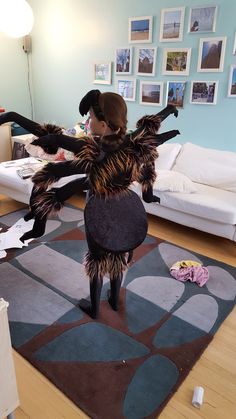 a woman is standing on her legs in an animal costume